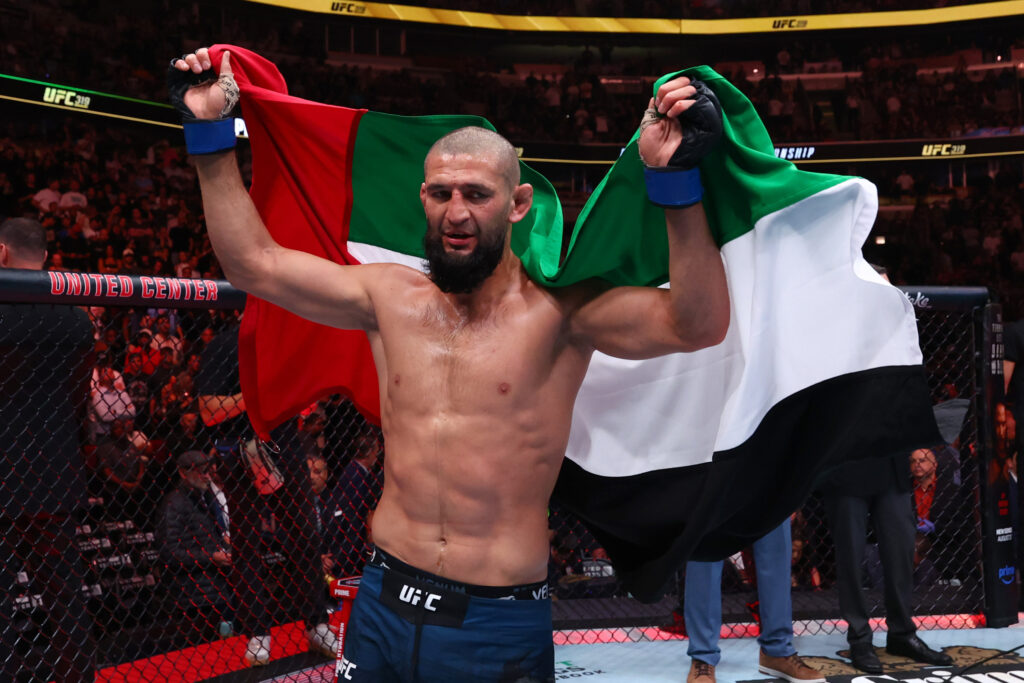 Khamzat Chimaev holds up the flag of Dubai after UFC 319 title win