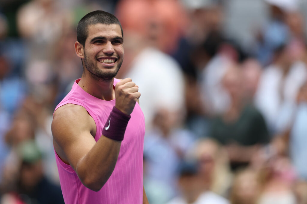 Carlos Alcaraz celebrating match point against Novak Djokovic at the 2025 US Open
