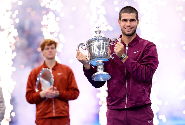 Carlos Alcaraz lifting the 2025 US Open trophy after defeating Jannik Sinner