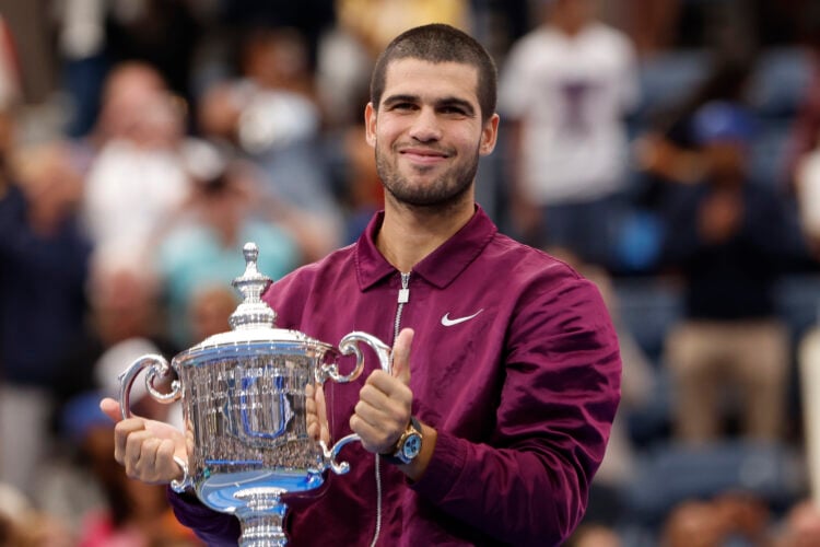 Carlos Alcaraz lifting the 2025 US Open trophy after defeating Jannik Sinner