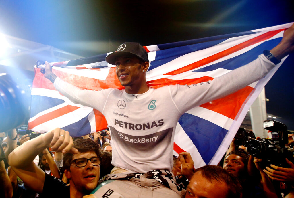 Lewis Hamilton of Great Britain and Mercedes GP celebrates with his team after winning the World Championship after the Abu Dhabi Formula One Grand Prix