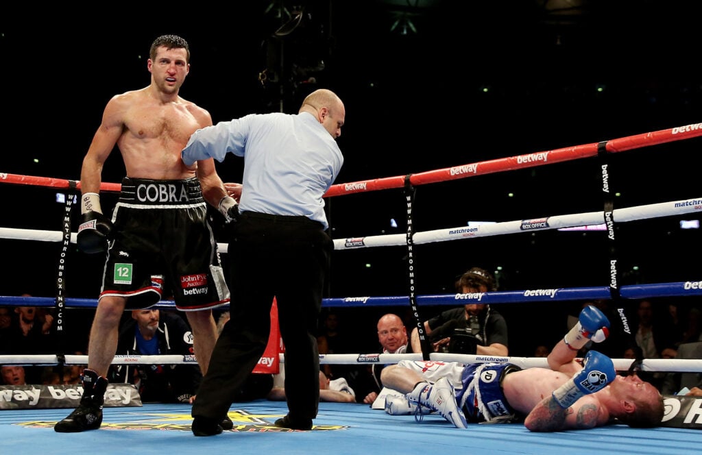 Carl Froch stands over George Groves after knocking him out