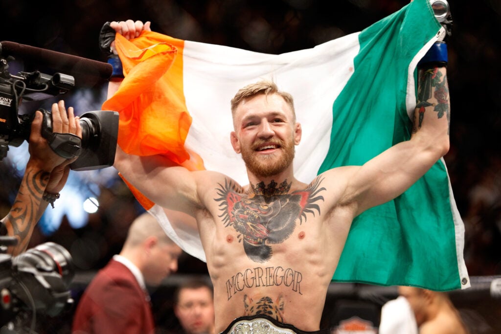 Conor McGregor celebrates defeating Jose Aldo