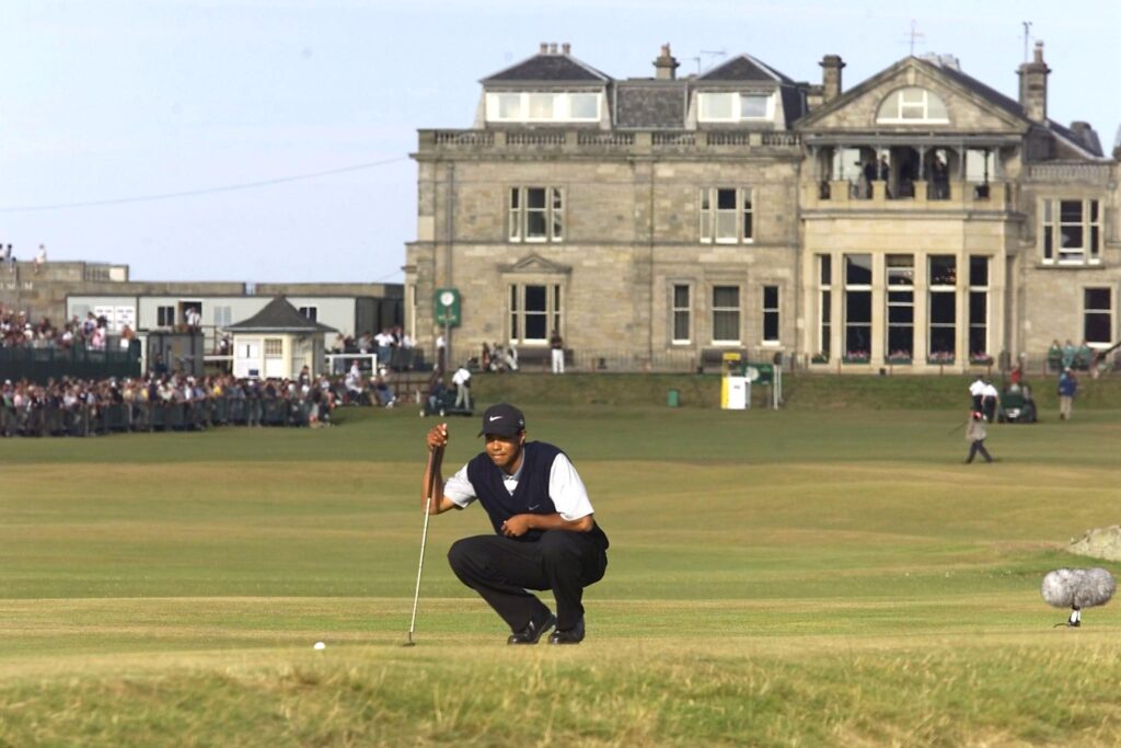 Tiger Woods lines up on the 17th green in front of the club house, at St. Andrews