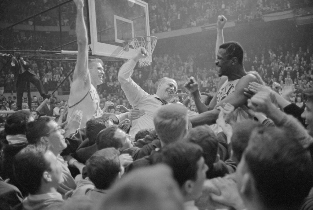 Fans carry Bill Russell (R) after the Celtics' 6th consecutive NBA title in 1964.