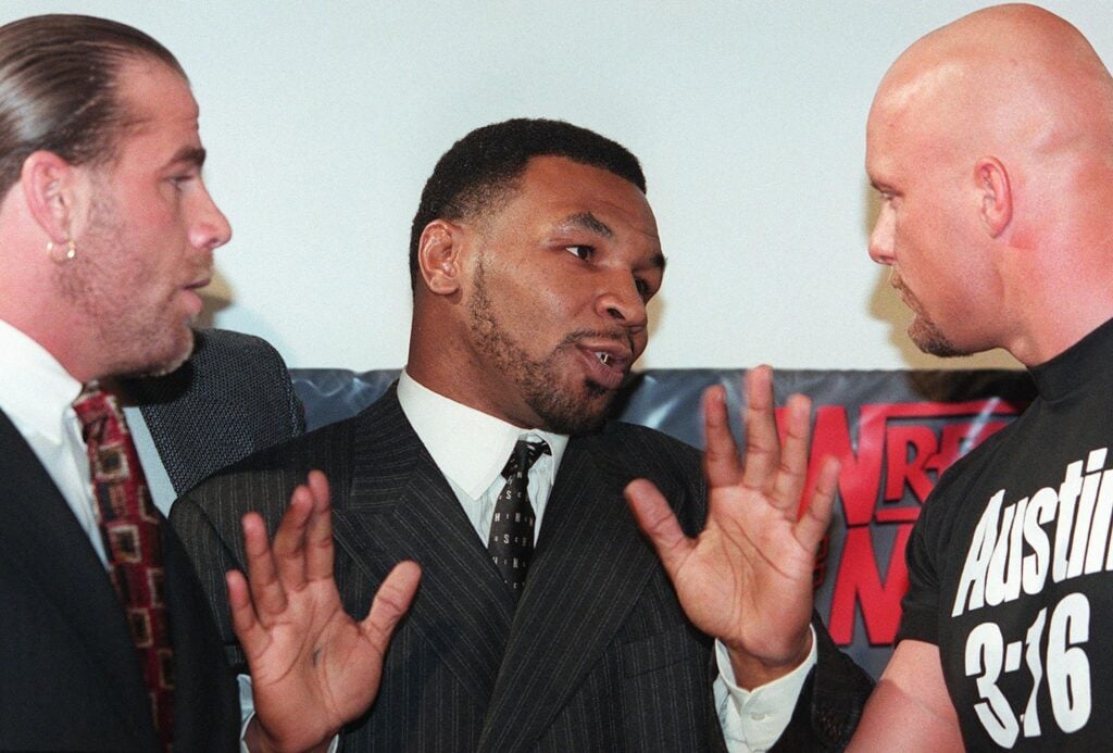 Shawn Michaels, Mike Tyson, and 'Stone Cold' Steve Austin during a WWE press conference in the Attitude Era