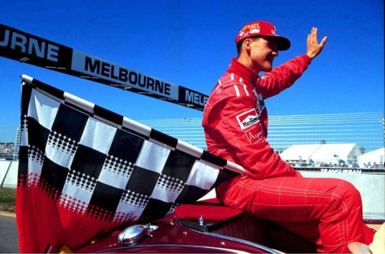 Michael Schumacher of Ferrari poses for a photo with a chequered flag at the 1996 Australian Grand Prix