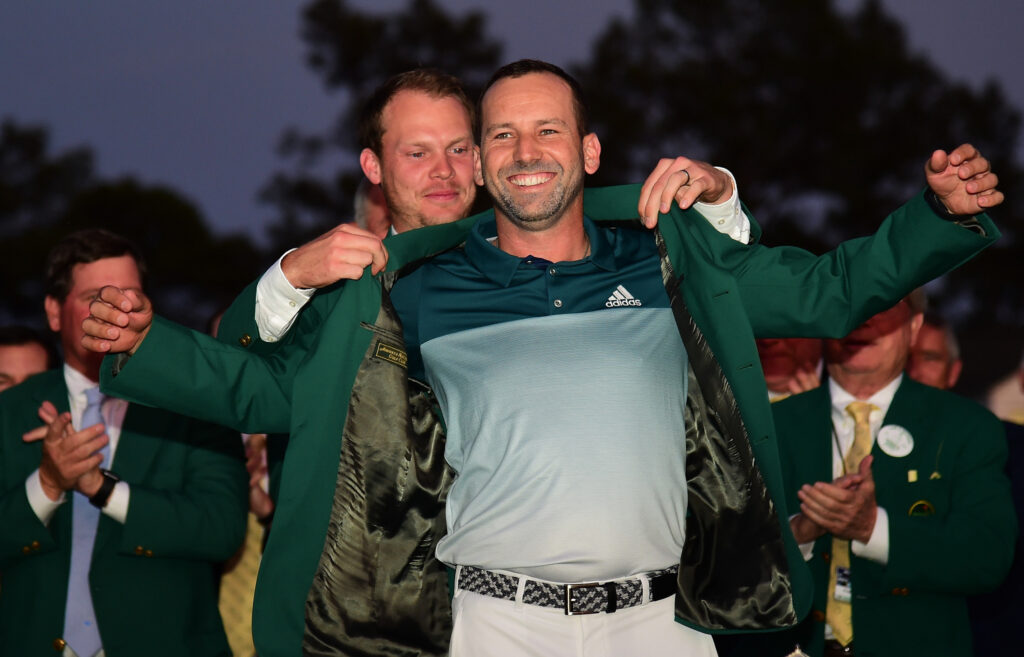 Danny Willett of England presents Sergio Garcia of Spain with the Green Jacket