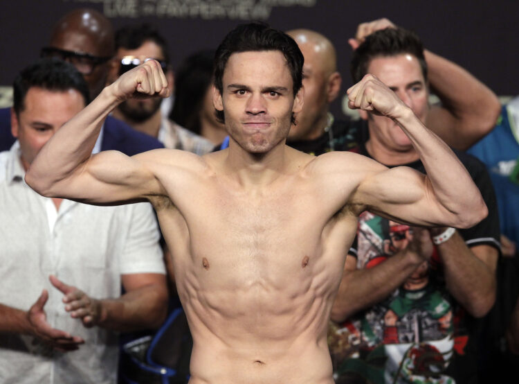 Julio Cesar Chavez, Jr. poses on the scales before his fight against Saul 'Canelo' Alvarez