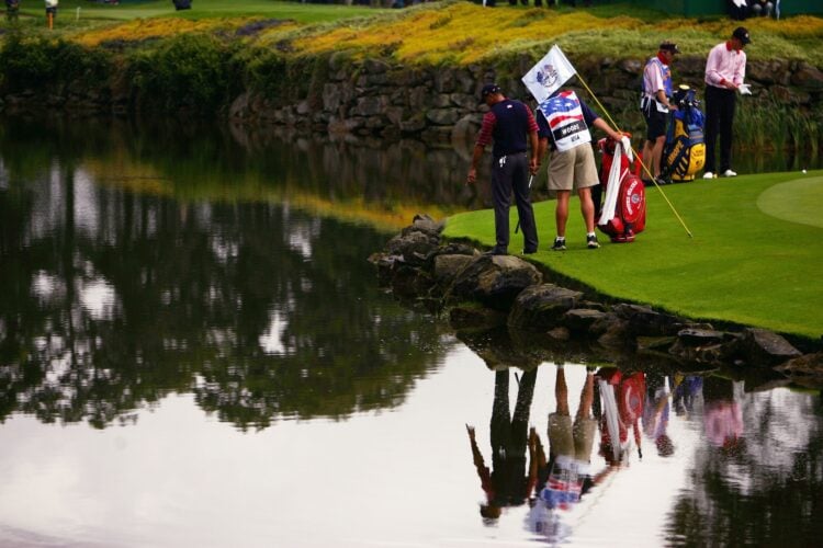 Tiger Woods points to his 9-iron in the lake at the 2006 Ryder Cup