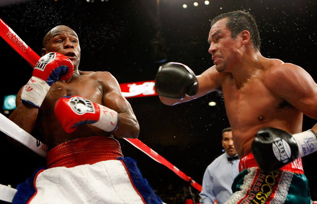 Floyd Mayweather Jr. and Juan Manuel Marquez exchange blows in the fourth round of their 2009 fight.