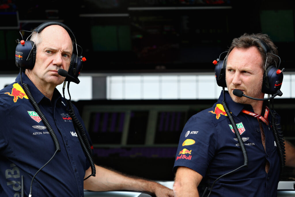 Christian Horner and Adrian Newey of Red Bull Racing look on from the pit wall