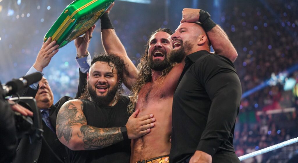 Seth Rollins celebrates with Bron Breakker and Bronson Reed after winning Money in the Bank
