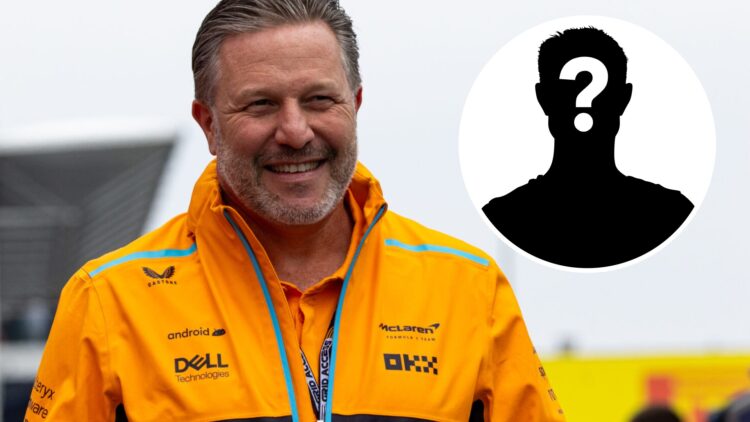 McLaren F1 team CEO Zak Brown (left) walks in the paddock, and a mystery person (right)