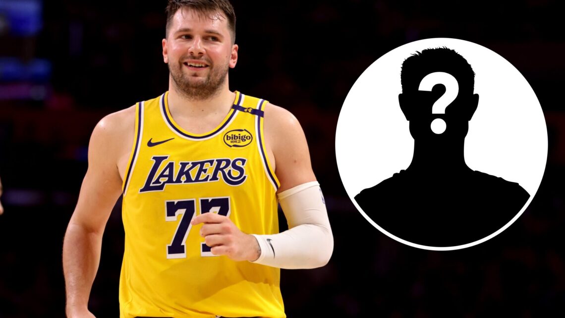 Luka Doncic (left) smiles in a game and a mystery person