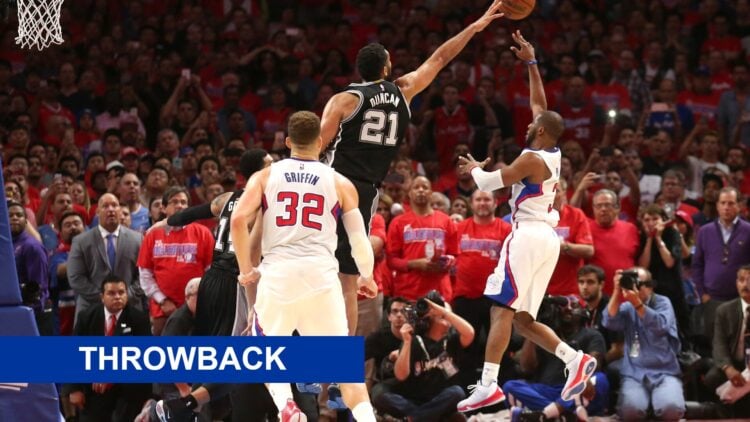 Chris Paul #3 of the Los Angeles Clippers puts up the game winning shot over Tim Duncan #21 of the San Antonio Spurs with a throwback banner