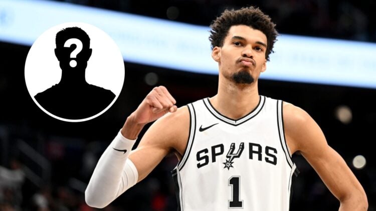 Victor Wembanyama #1 of the San Antonio Spurs celebrates (right) and a mystery person (left)
