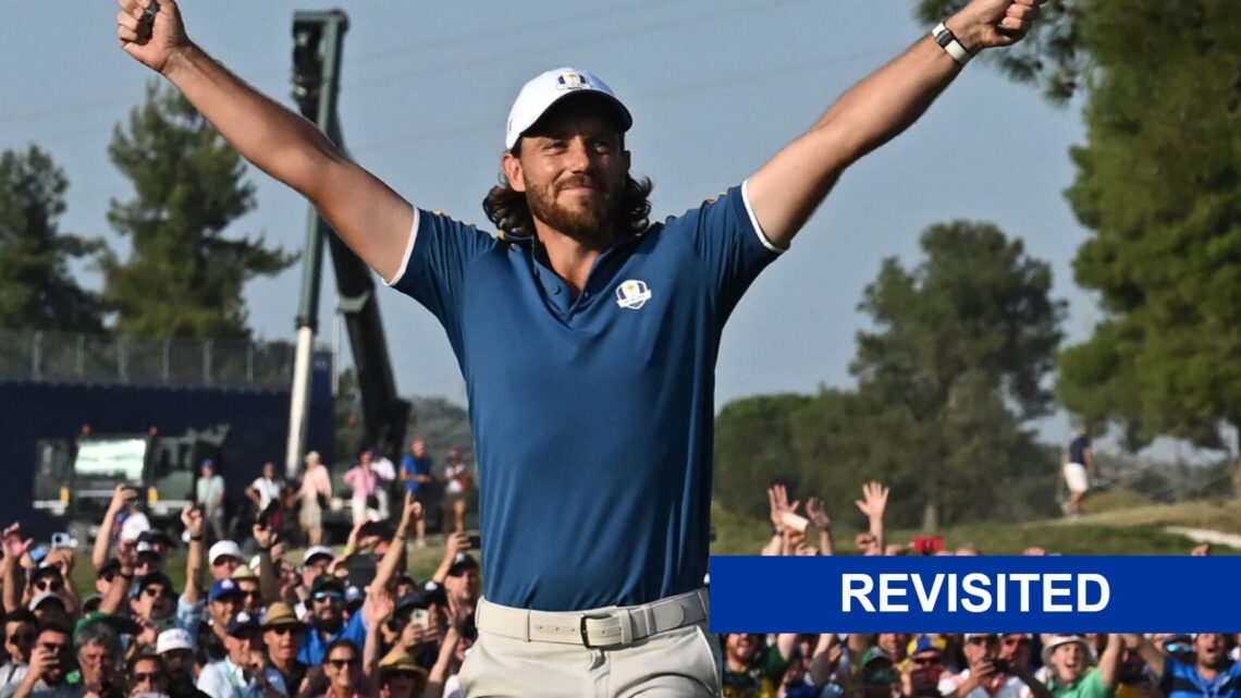 Tommy Fleetwood celebrates the Ryder Cup winning putt on the 17th green with a revisited banner